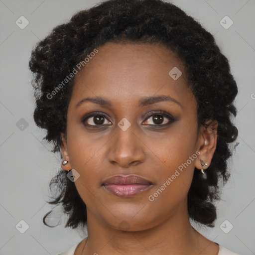 Joyful black young-adult female with medium  brown hair and brown eyes