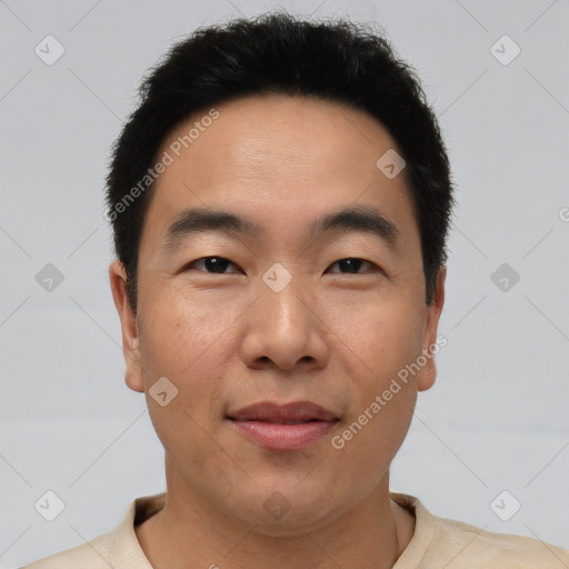 Joyful asian young-adult male with short  brown hair and brown eyes