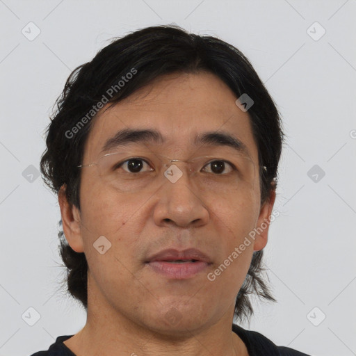 Joyful asian adult male with short  brown hair and brown eyes