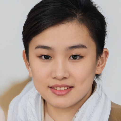 Joyful asian young-adult female with short  brown hair and brown eyes