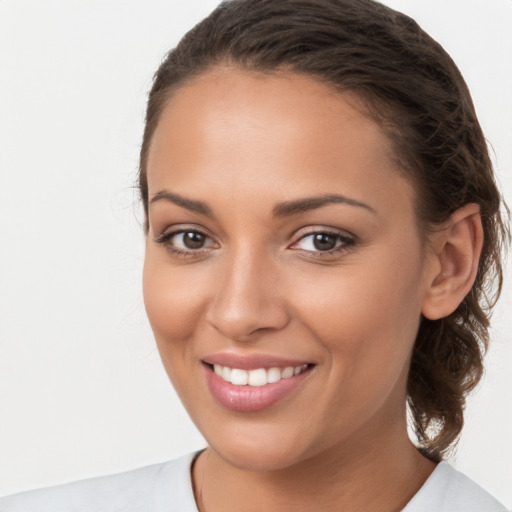 Joyful white young-adult female with long  brown hair and brown eyes