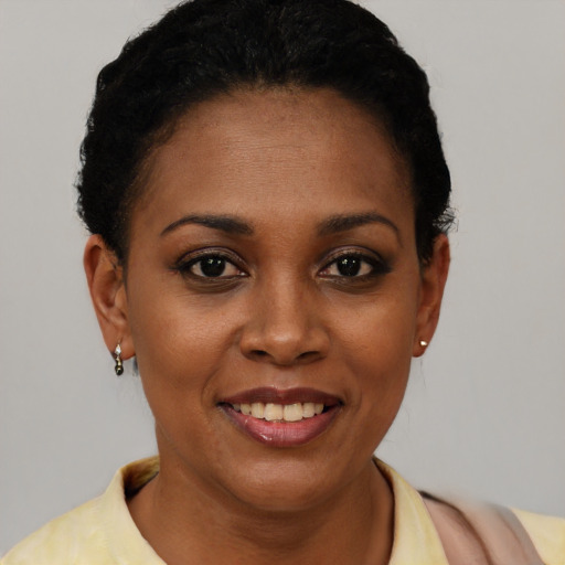 Joyful latino young-adult female with short  black hair and brown eyes