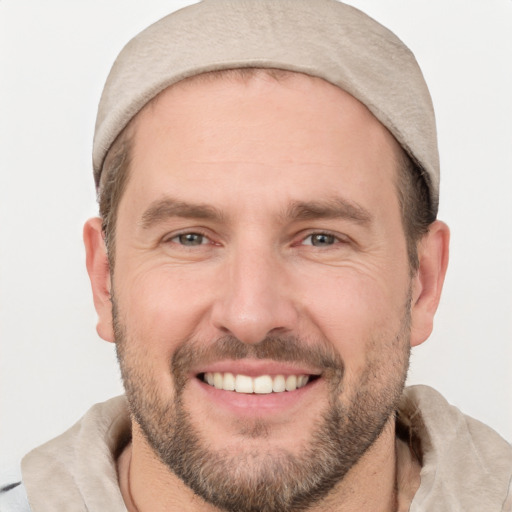 Joyful white adult male with short  brown hair and brown eyes