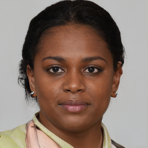 Joyful black young-adult female with medium  brown hair and brown eyes