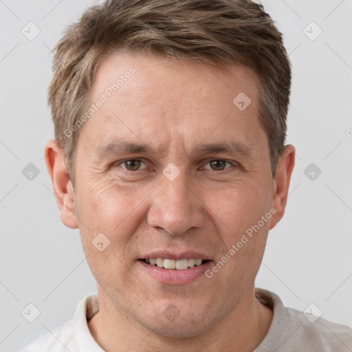 Joyful white adult male with short  brown hair and grey eyes