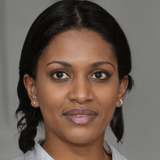 Joyful black young-adult female with medium  brown hair and brown eyes