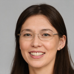 Joyful white adult female with long  brown hair and brown eyes