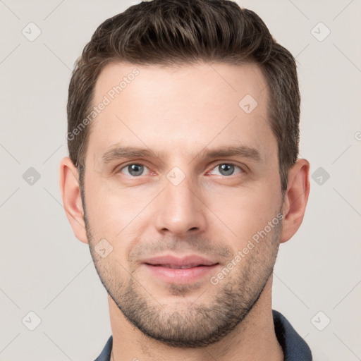 Joyful white young-adult male with short  brown hair and grey eyes