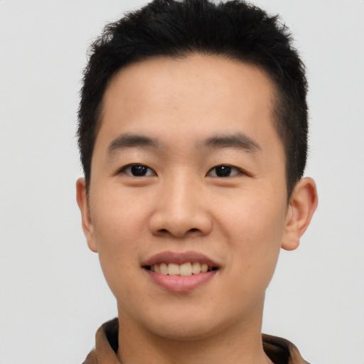 Joyful asian young-adult male with short  brown hair and brown eyes