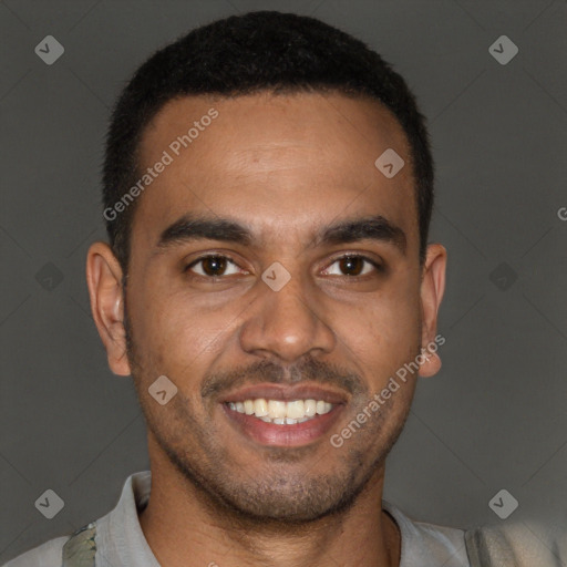 Joyful black young-adult male with short  brown hair and brown eyes