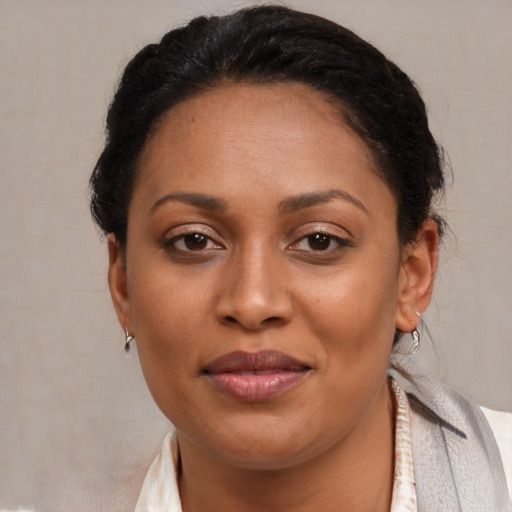 Joyful latino adult female with short  brown hair and brown eyes
