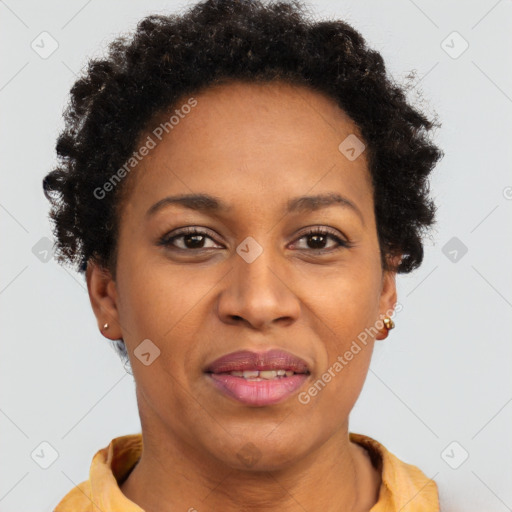 Joyful black adult female with short  brown hair and brown eyes