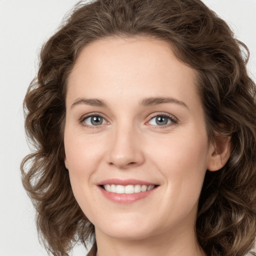 Joyful white young-adult female with long  brown hair and green eyes