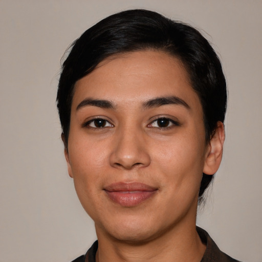 Joyful latino young-adult female with short  black hair and brown eyes