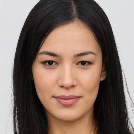 Joyful asian young-adult female with long  brown hair and brown eyes