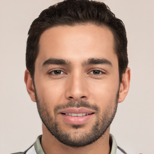 Joyful white young-adult male with short  black hair and brown eyes