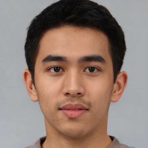 Neutral latino young-adult male with short  brown hair and brown eyes