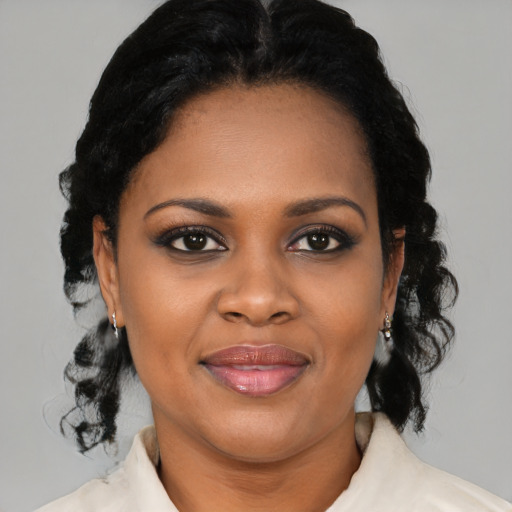 Joyful black young-adult female with medium  black hair and brown eyes