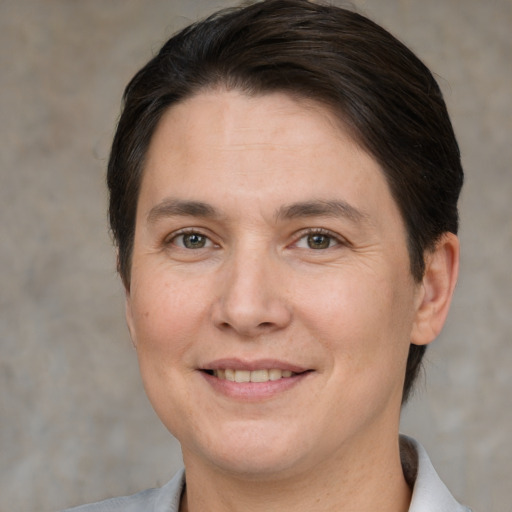 Joyful white adult female with short  brown hair and brown eyes