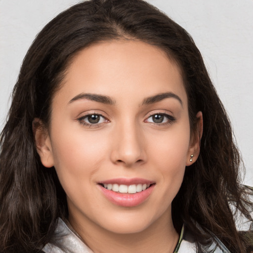 Joyful white young-adult female with long  brown hair and brown eyes