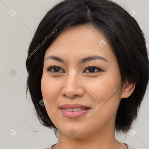 Joyful asian young-adult female with medium  brown hair and brown eyes