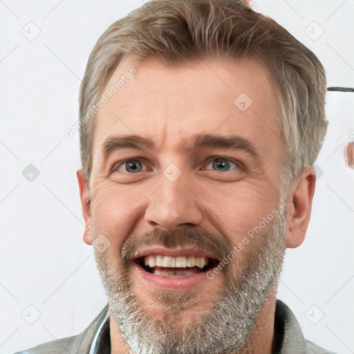 Joyful white adult male with short  brown hair and grey eyes