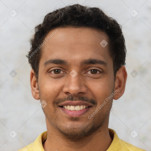 Joyful latino young-adult male with short  brown hair and brown eyes
