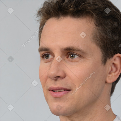 Joyful white adult male with short  brown hair and brown eyes