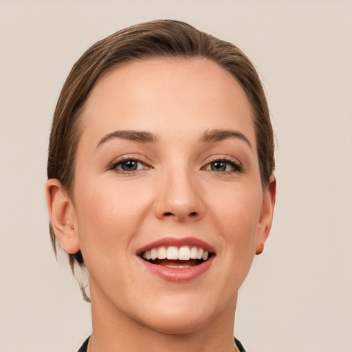 Joyful white young-adult female with short  brown hair and grey eyes