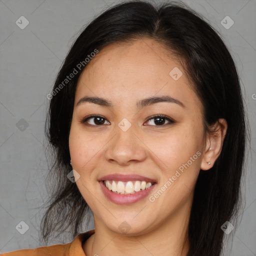 Joyful latino young-adult female with long  brown hair and brown eyes