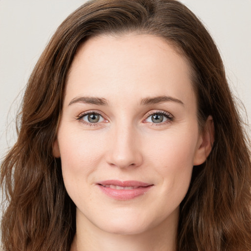 Joyful white young-adult female with long  brown hair and green eyes