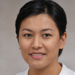 Joyful asian young-adult female with short  brown hair and brown eyes