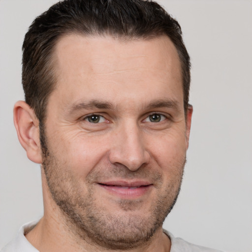 Joyful white adult male with short  brown hair and brown eyes