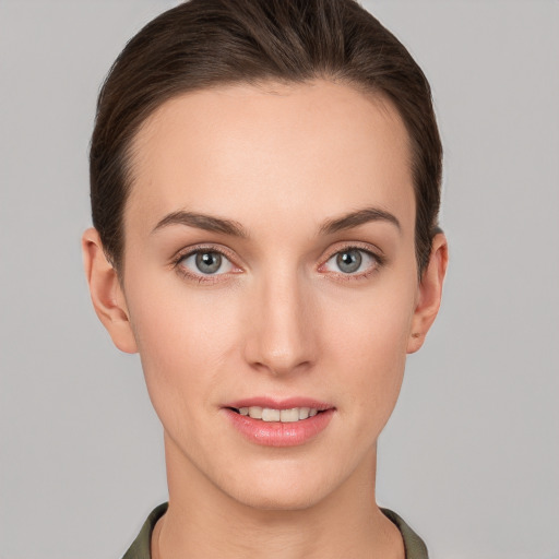 Joyful white young-adult female with short  brown hair and grey eyes