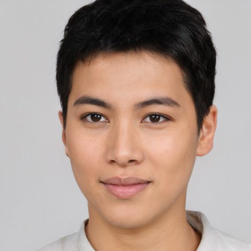 Joyful asian young-adult male with short  black hair and brown eyes
