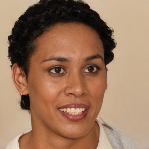 Joyful latino young-adult female with short  brown hair and brown eyes