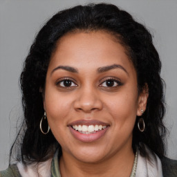 Joyful latino young-adult female with long  brown hair and brown eyes