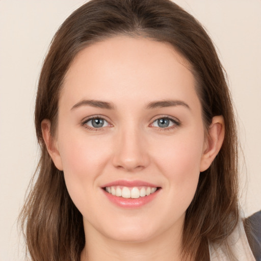 Joyful white young-adult female with long  brown hair and grey eyes