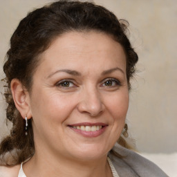 Joyful white adult female with medium  brown hair and brown eyes