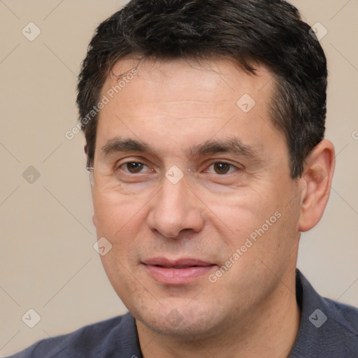 Joyful white adult male with short  black hair and brown eyes