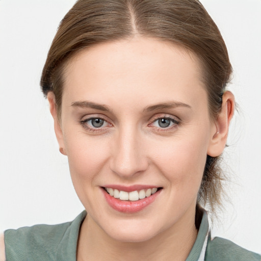 Joyful white young-adult female with medium  brown hair and blue eyes