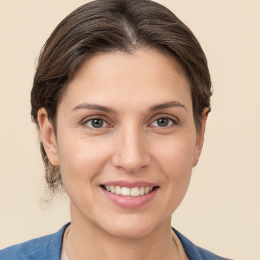 Joyful white young-adult female with short  brown hair and brown eyes