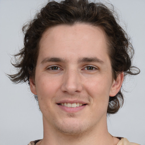 Joyful white young-adult male with medium  brown hair and brown eyes