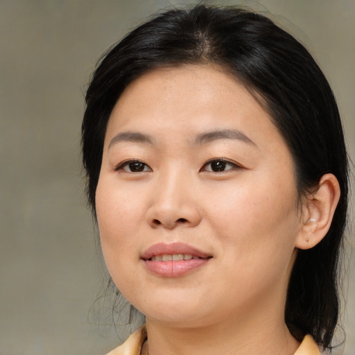 Joyful asian young-adult female with medium  black hair and brown eyes
