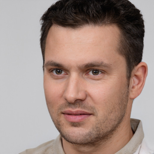 Joyful white young-adult male with short  brown hair and brown eyes