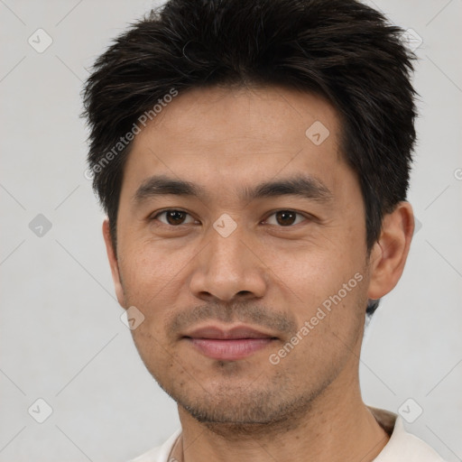 Joyful white young-adult male with short  black hair and brown eyes