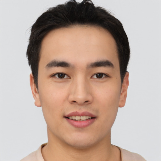 Joyful asian young-adult male with short  black hair and brown eyes