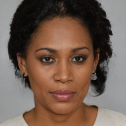 Joyful black young-adult female with medium  brown hair and brown eyes