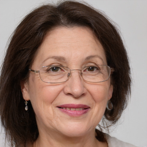 Joyful white middle-aged female with medium  brown hair and grey eyes