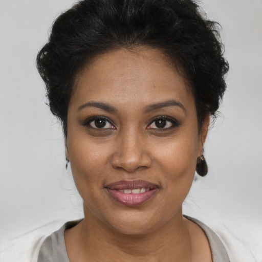 Joyful black young-adult female with short  brown hair and brown eyes